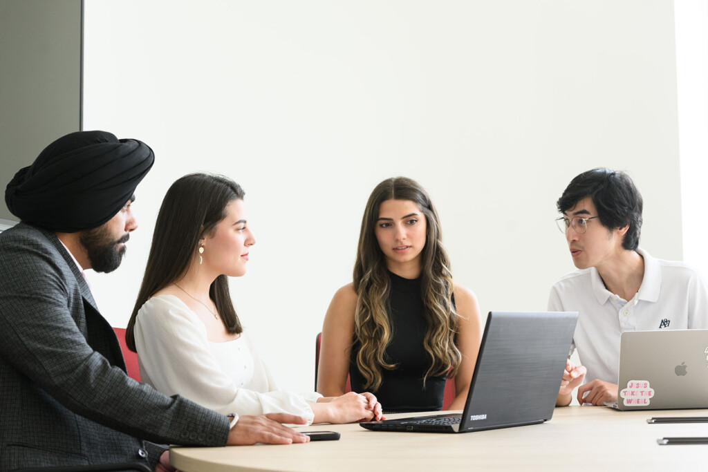 Group of Master of Accounting students discussing an accounting case in the Sprott School of Business at Carleton University in Ottawa, Ontario, Canada.