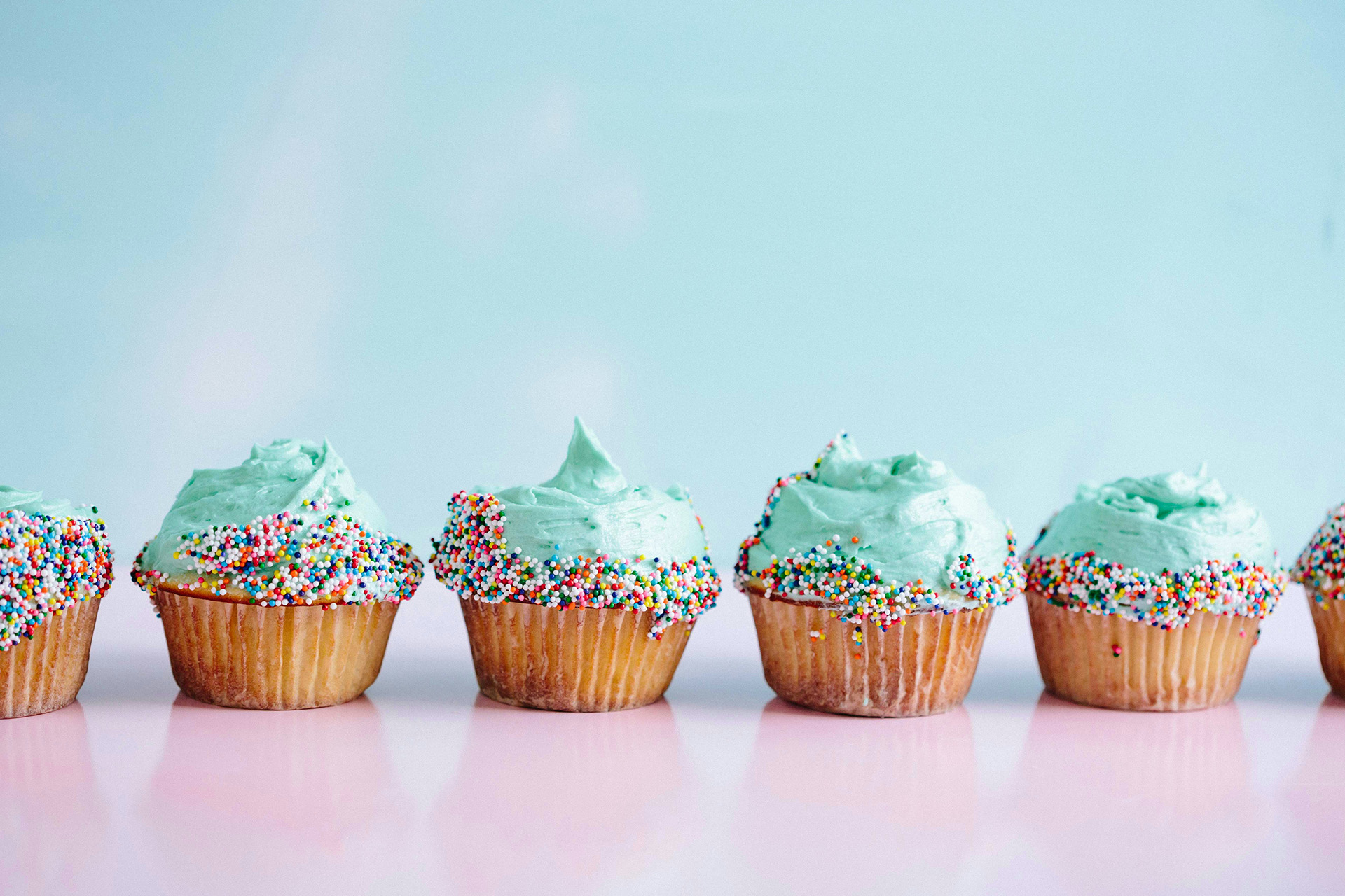 Colourful cupcakes dipped in sprinkles