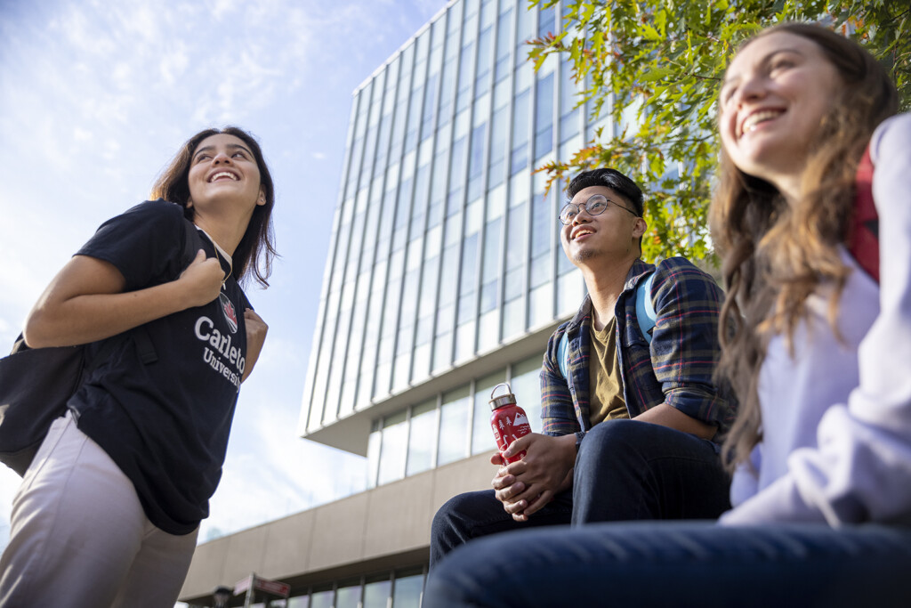 Group of Carleton University students laughing together on the Carleton campus in Ottawa, Ontario, Canada.