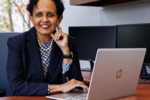 Uma Gupta at a desk with a computer
