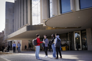 Sprott graduate students having a discussion in front of the Nicol Building at Carleton University.