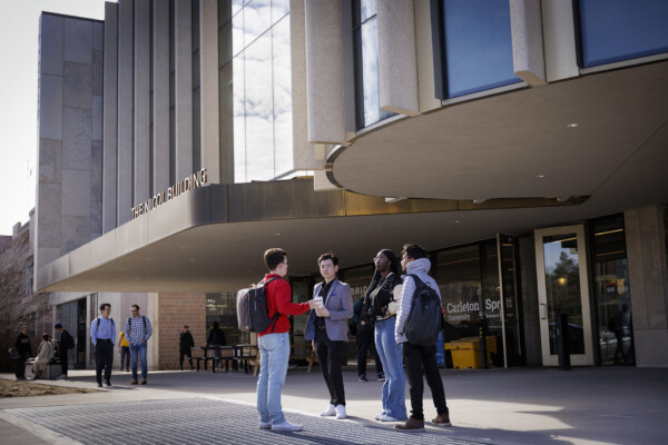 Sprott graduate students having a discussion in front of the Nicol Building at Carleton University.