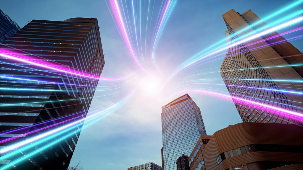 City high rise office building with a neon lights radiating from the centre.