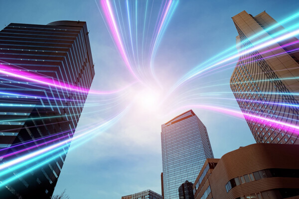 City high rise office building with a neon lights radiating from the centre.