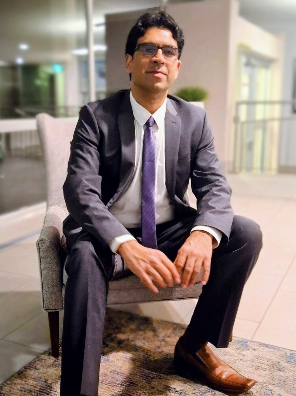 Asit Kaul sitting in a chair