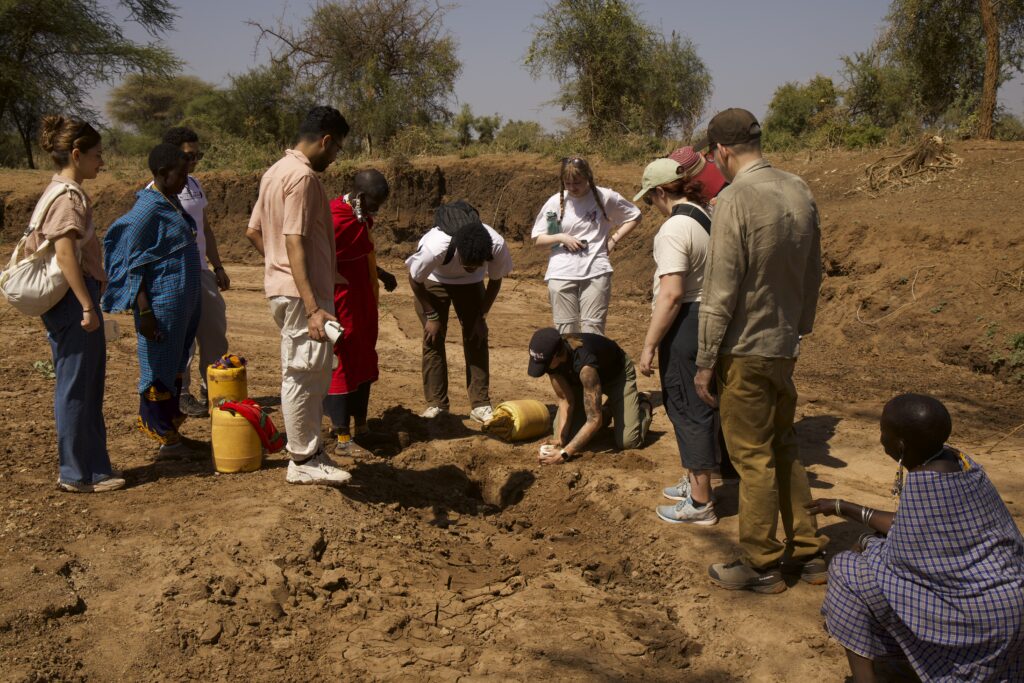 Digging for water in riverbed