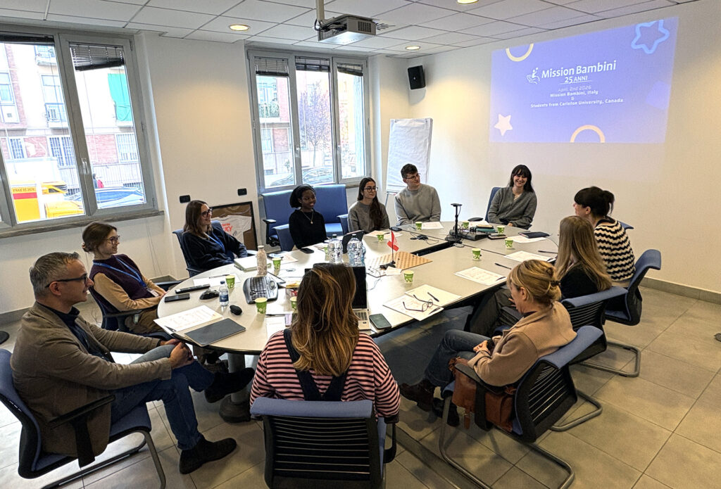 Sprott Student Impact Hub students working with the team from Mission Bambini onsite in Milan, Italy.