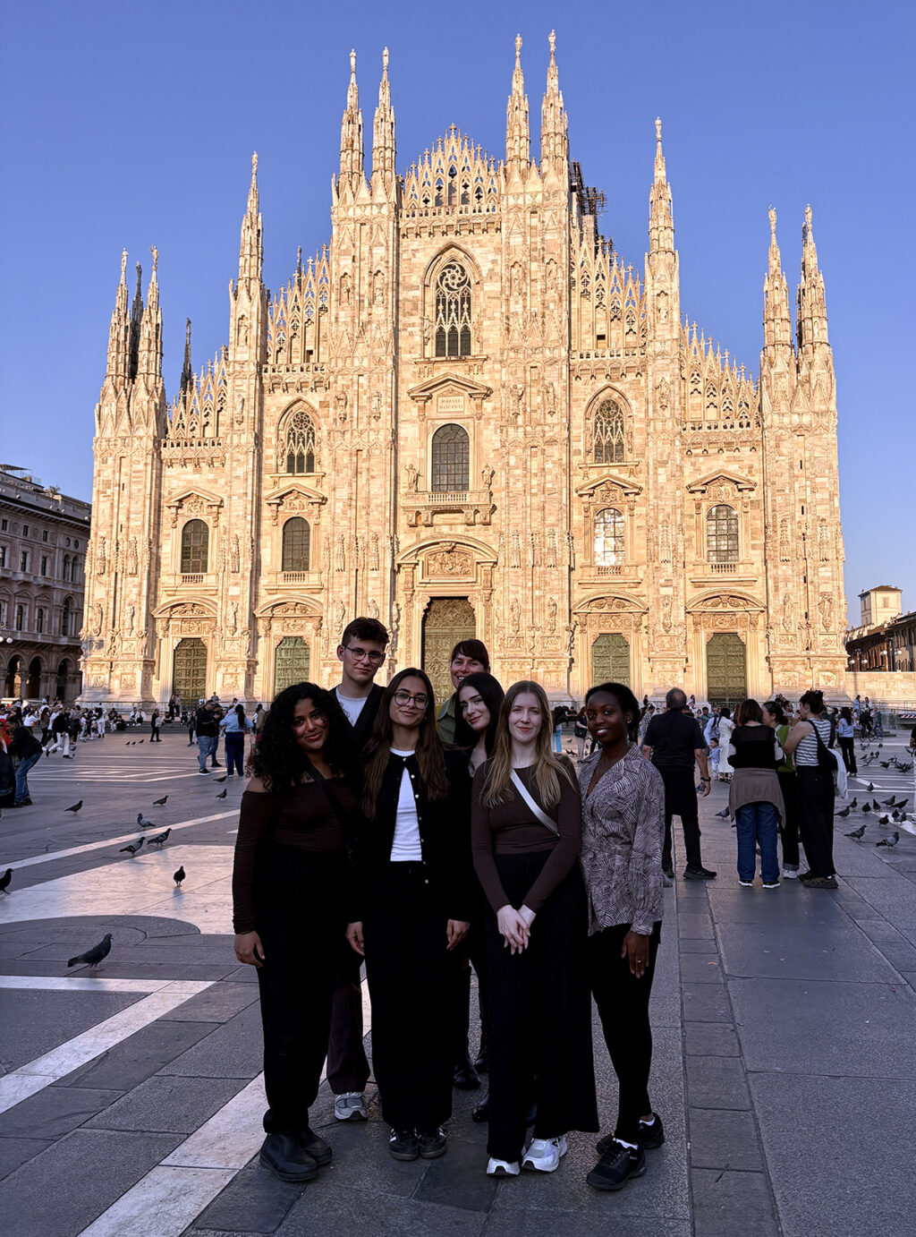 Students in the Sprott Social Impact Hub in front of the Duomo di Milano in Milan, Italy.