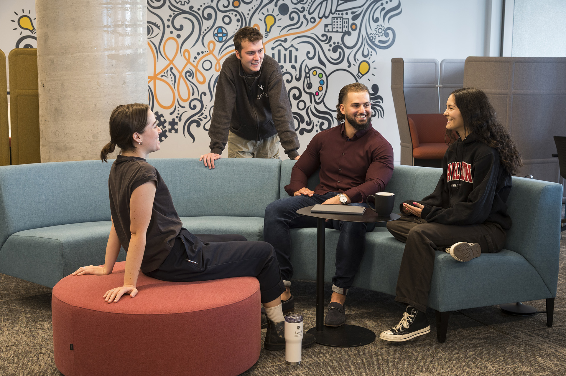 Students having a discussion in the Innovation Hub at Carleton University's Sprott School of Business.