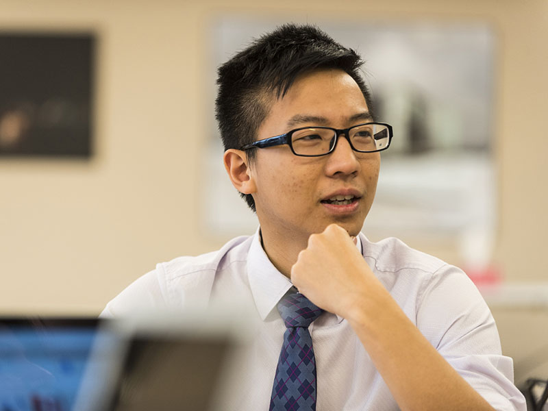 Asian male MBA student pausing in conversation