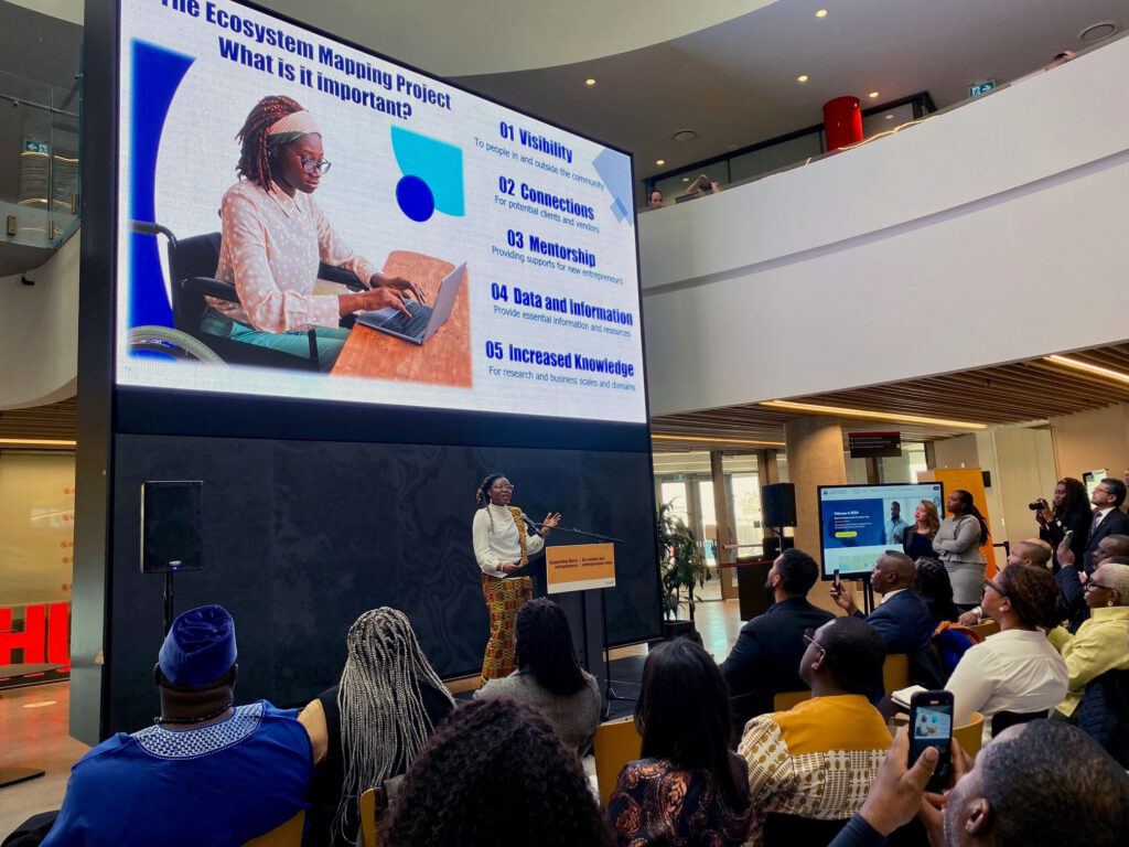 Deborah Allotey, ecosystem mapping coordinator for the Black Entrepreneurship Knowledge Hub, previews the new tool to Minister Rechie and guests. at Carleton University's Sprott School of Business on Feburary 8, 2024.