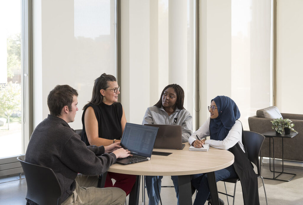 Accounting students meeting with Professor Rebecca Renfroe at Carleton University's Sprott School of Business in Ottawa, Canada.