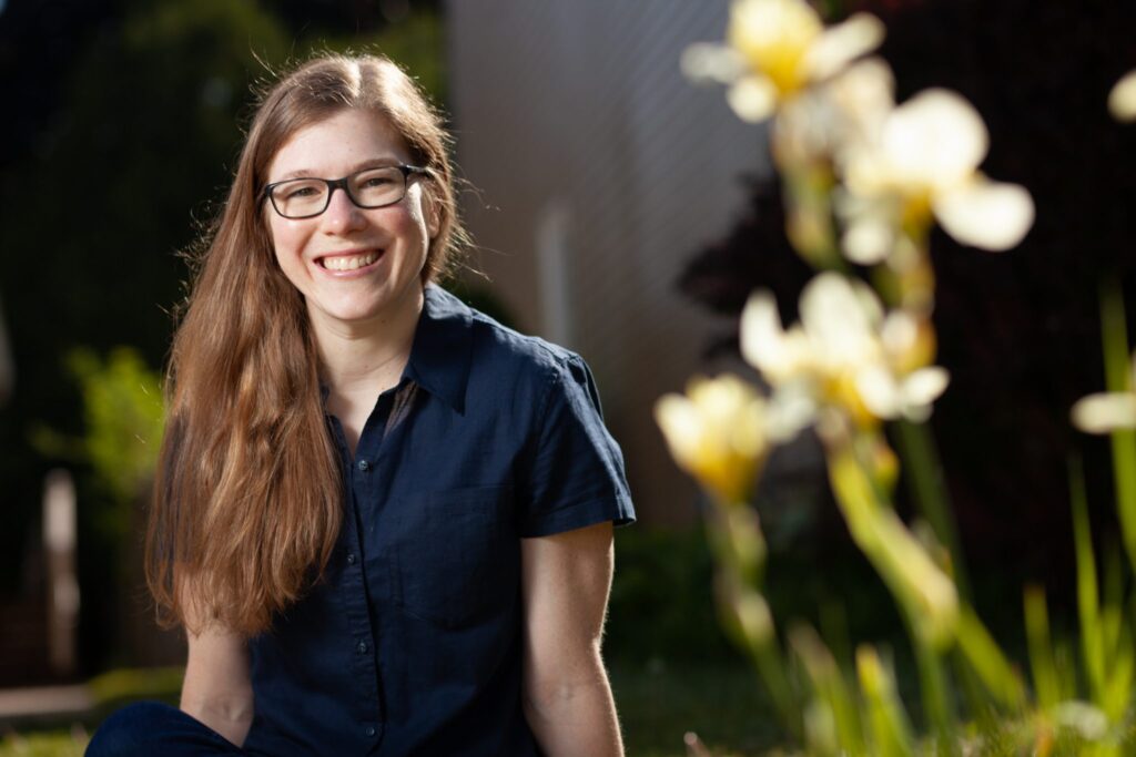 Photo of Carleton Vanier Scholar recipient Chelsie Smith sitting near flowers.