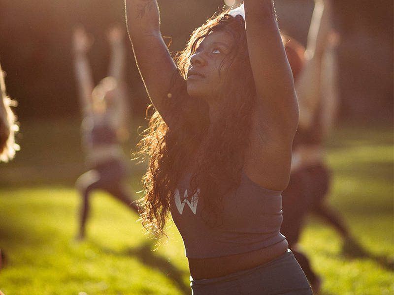 Chongo in a yoga pose in the park