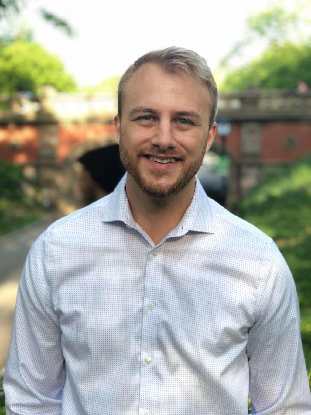 photo of Chris Bailey in front of a bridge