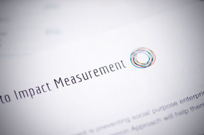 Close up of paper with part of the title showing that reads, "Impact Measurement"