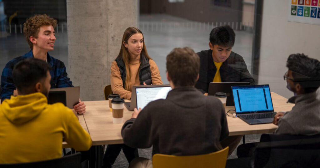 Group of students meeting in the Innovation Hub at Carleton University's Sprott School of Business.