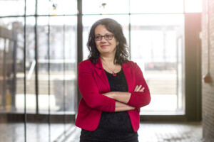 Luciara Nardon, associate professor on international business at the Sprott School of Business, standing in front of a window at Carleton University.