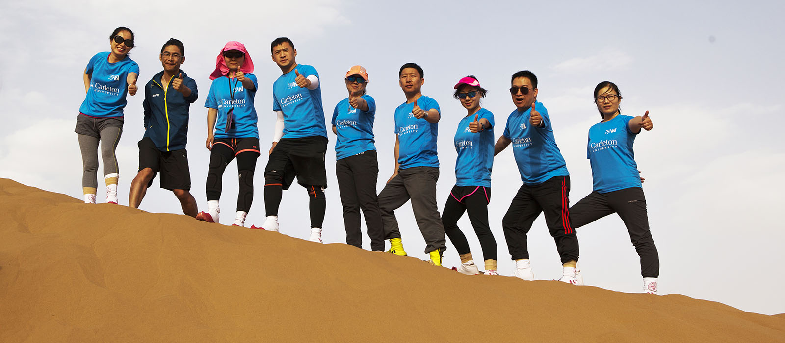 The Sprott MBA Shanghai student team lined up on a sand dune at the 2018 Asia-Pacific Desert Challenge in the Gobi Desert.