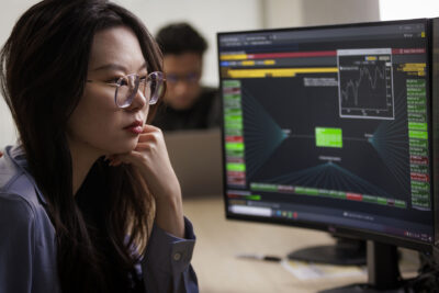 Master of Finance students working at a Bloomberg terminal at Carleton University's Sprott School of Business in Ottawa, Canada.