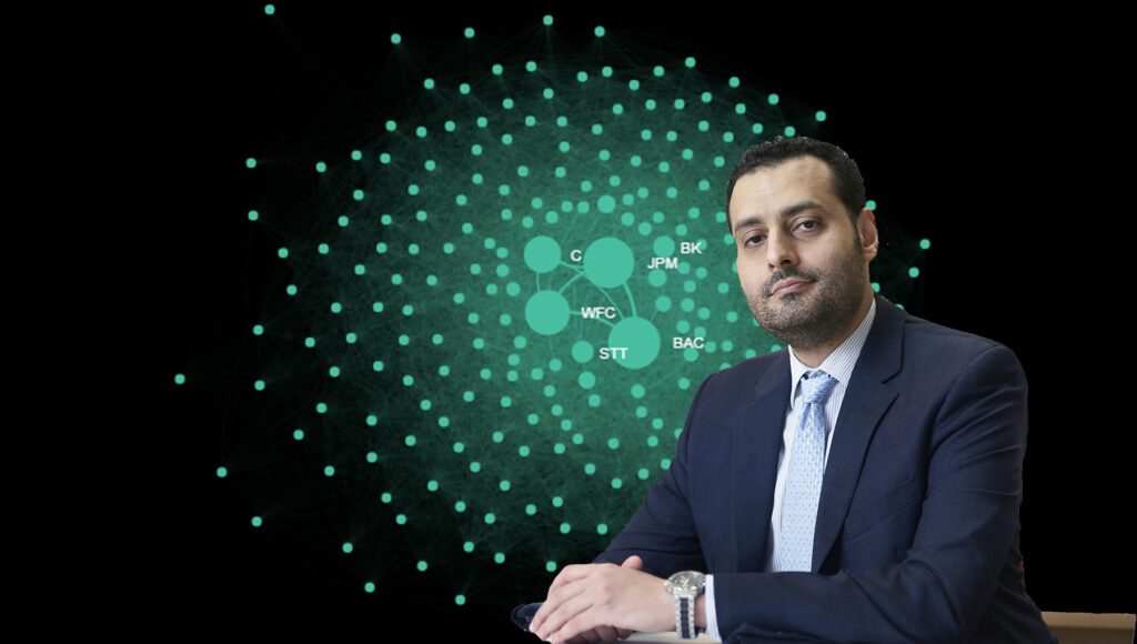 Mohamed Al Guindy, assistant professor of finance at Carleton's Sprott School of Business, in front of an image of his creation 