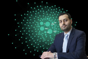 Mohamed Al Guindy, assistant professor of finance at Carleton's Sprott School of Business, in front of an image of his creation 