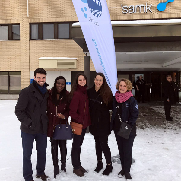 Students and coach standing outside Satakunta University in Rauma, Finland.