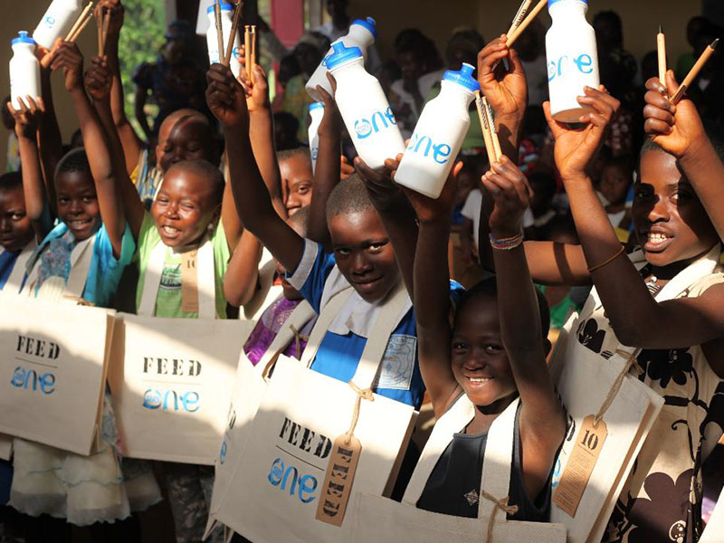 School children in Cameroon receiving school supplies from One Young World.