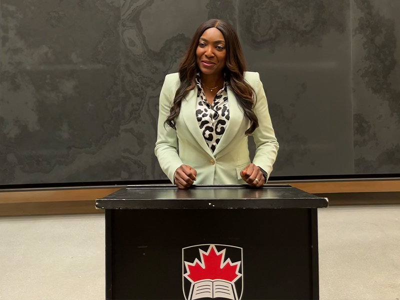 Patricia Bebia Mawa standing behind a pedestal