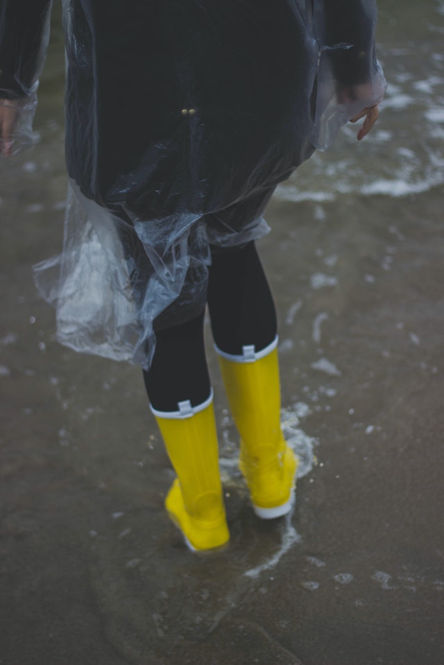 Person wearing yellow rainboots in flood