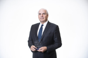 portrait of Phillip Taylor holding Sprott alumni award