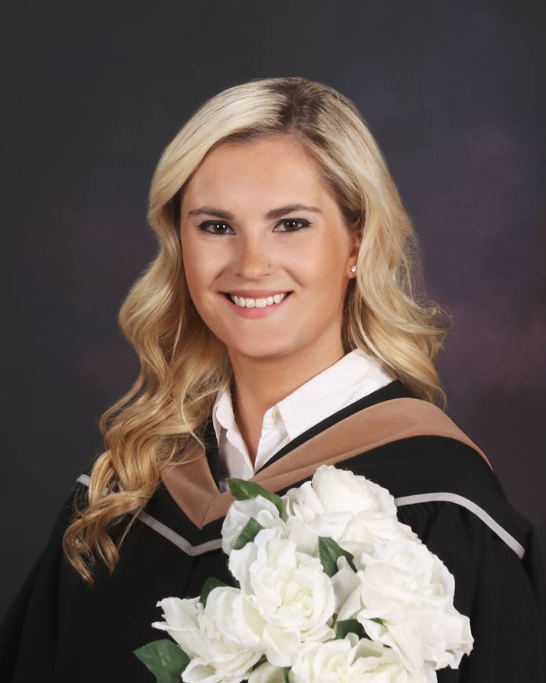 a graduation photo of Sophia in her gown and hood.