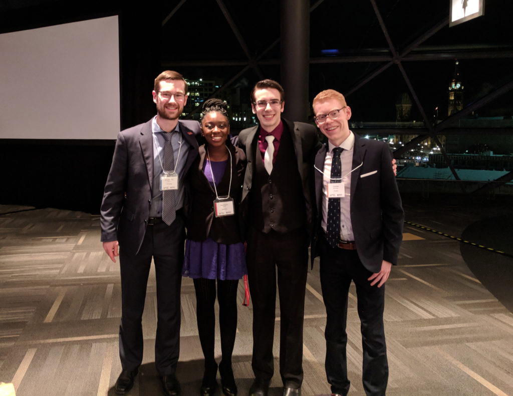 Chris with 3 other friends at the banquet