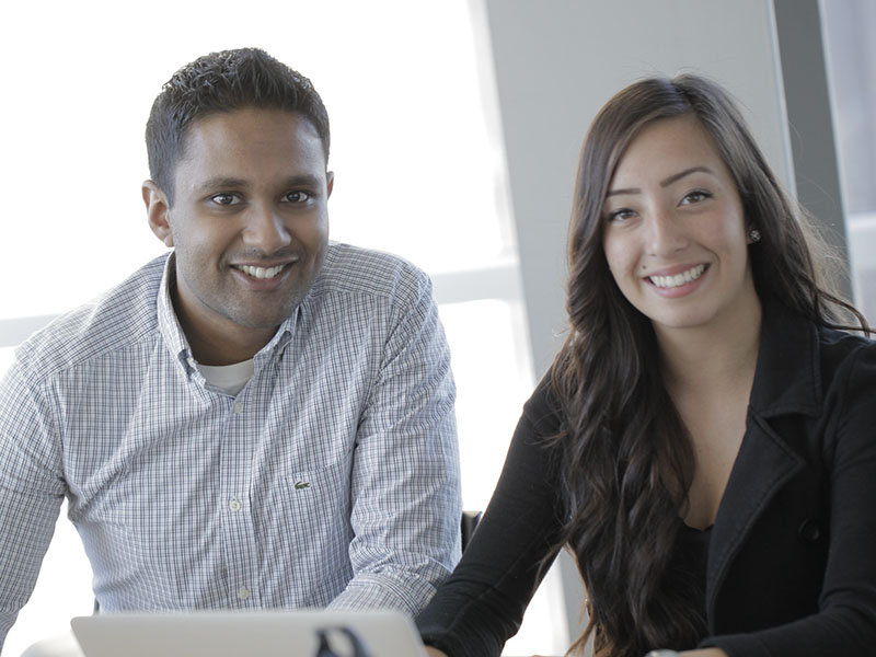 Two Sprott Bachelor of Commerce students - one male, one female - working together.