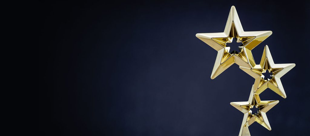 Trophy with three gold stars set against a black background