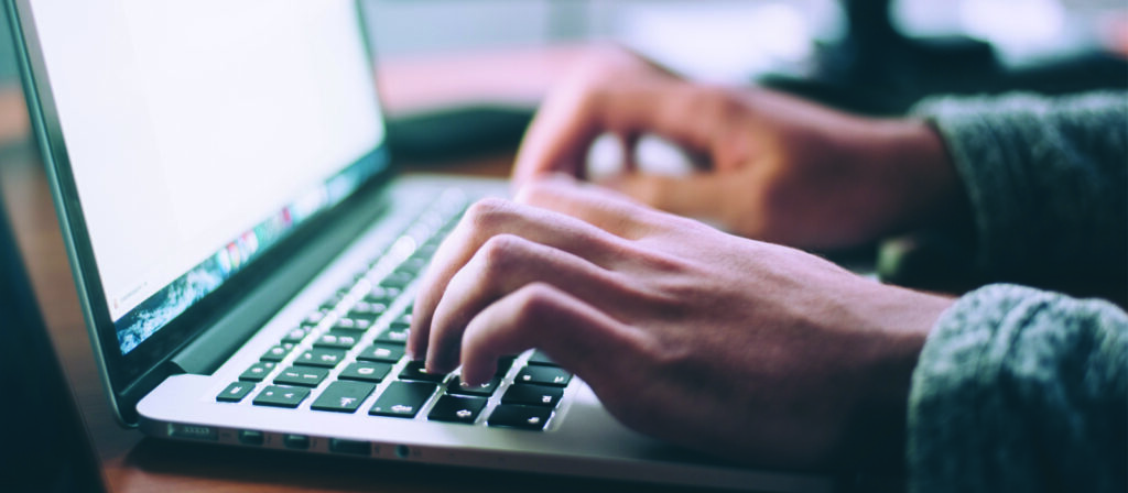 hands on a laptop keyboard