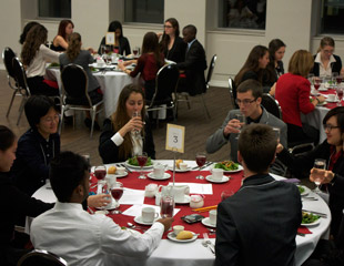 Students learning proper table manners at BCMC's Etiquette Dinner.