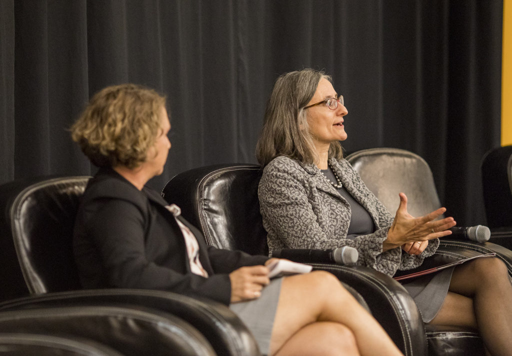 Christine and Linda speaking to each other in big chairs