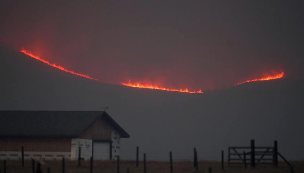 a ring of fire emerging from the smokey mountain tops.