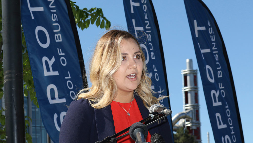 Hannah speaking at the podium