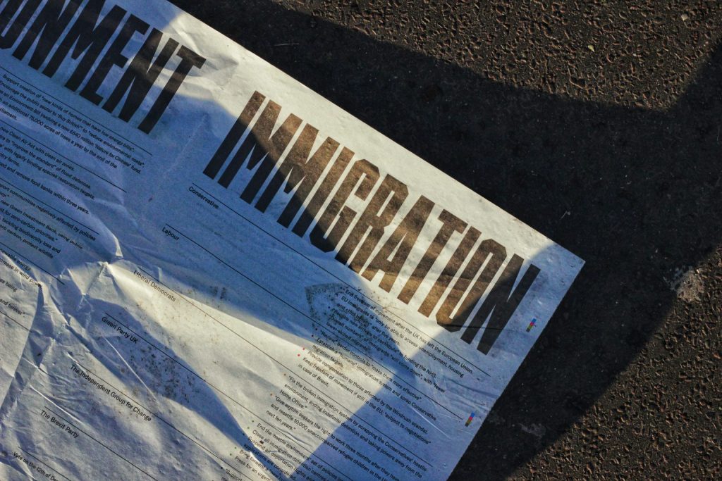 An immigration flyer on the pavement