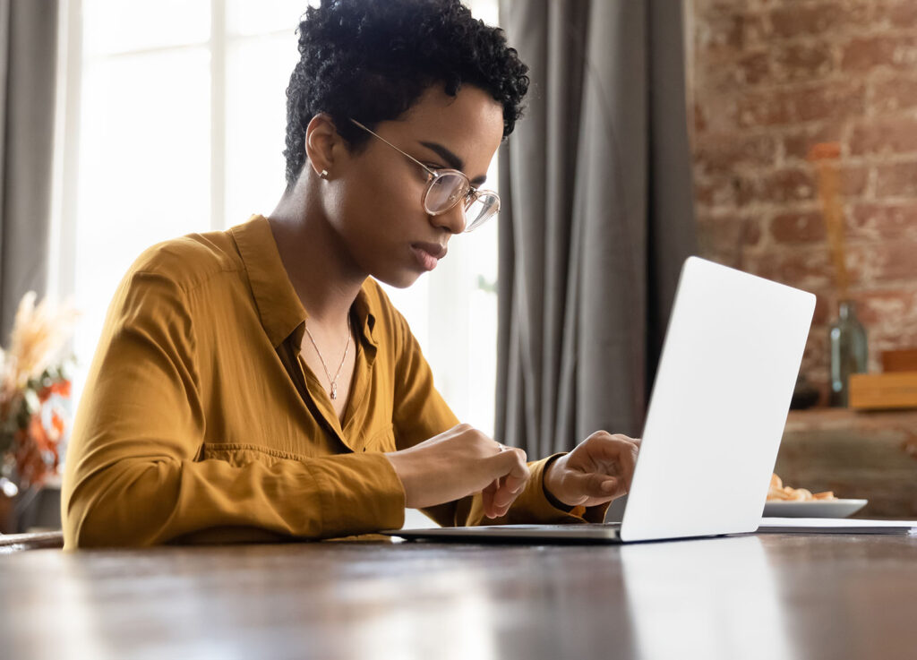 young black women working on a laptop in her living room