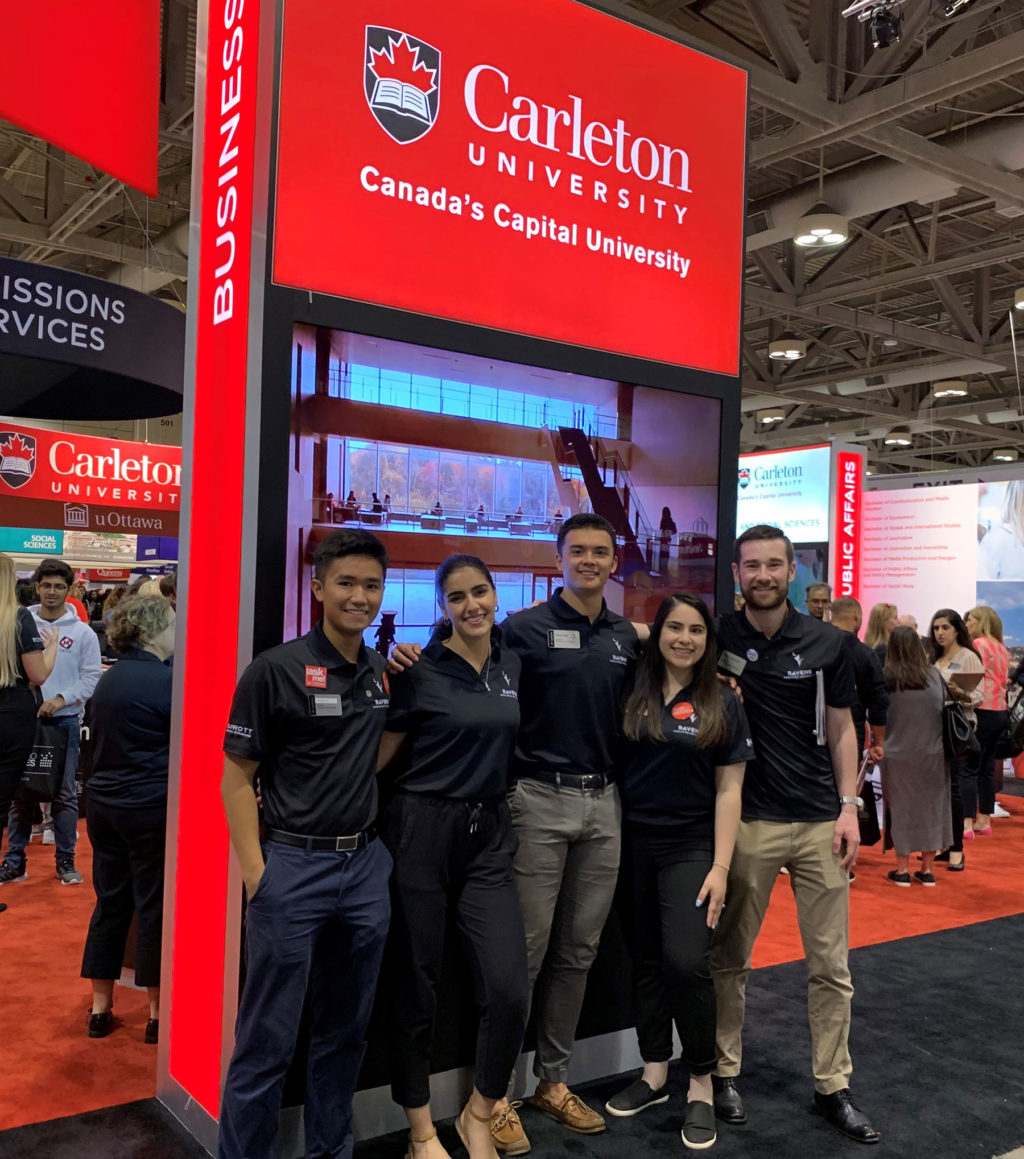 Lina with 4 other Sprott students wearing matching polo shirts at the Ontario Universities Fair