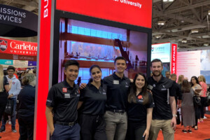 Lina with 4 other Sprott students wearing matching polo shirts at the Ontario Universities Fair