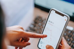 a male pointing to a chart on his phone