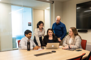 Sprott students in a board room
