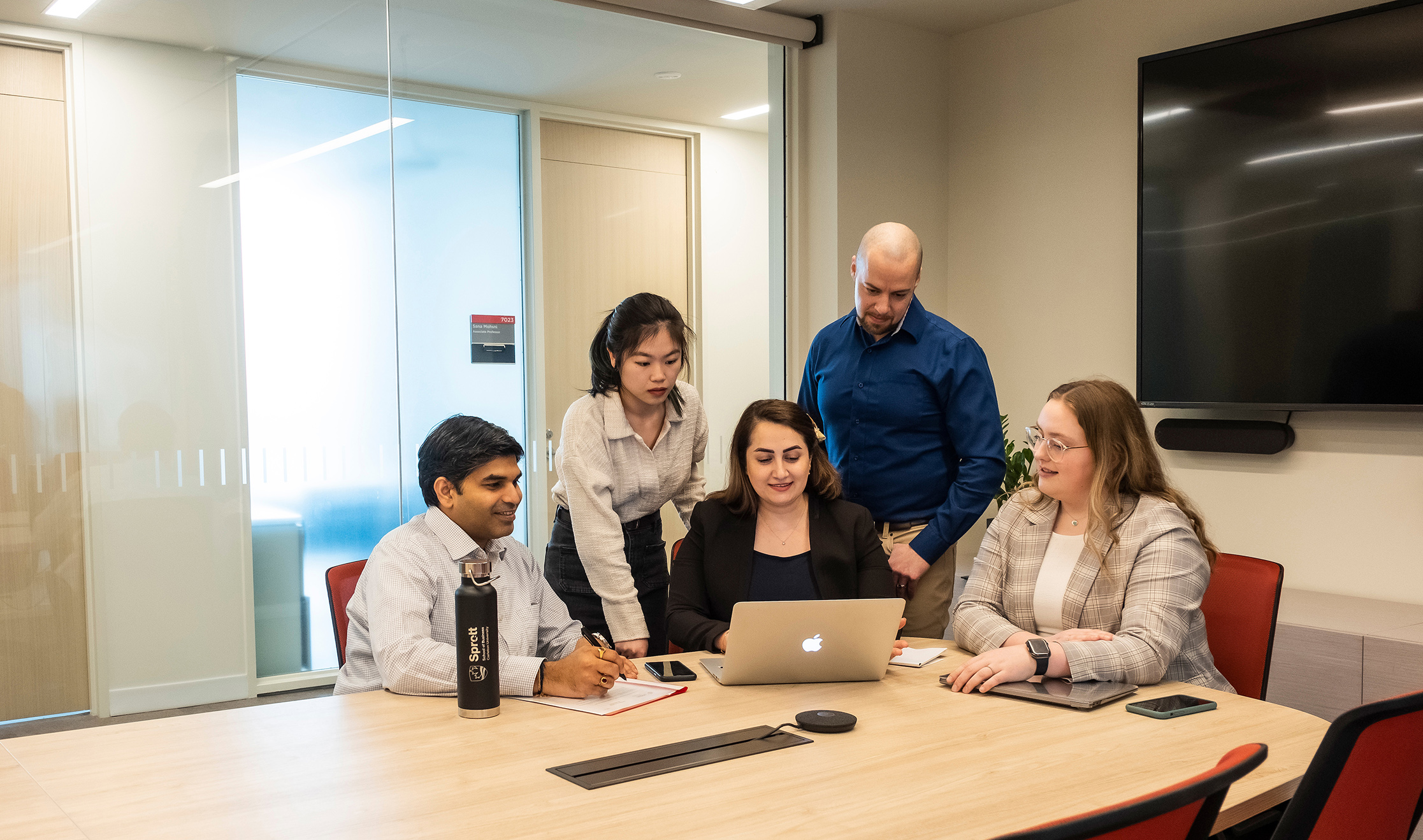 Sprott students in a board room