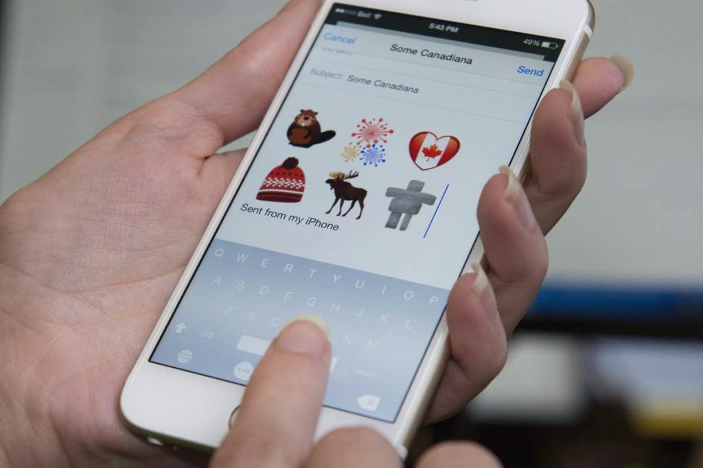 A hand holding a phone displaying new Time Hortons emojis.