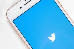 iphone showing the Twitter logo on the screen.